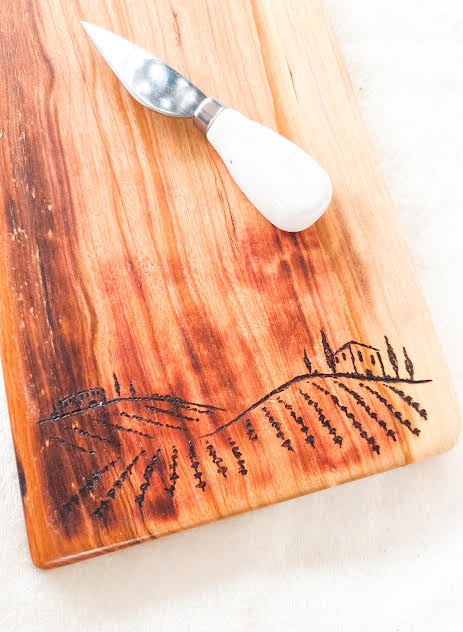 Wine bottle charcuterie board with vineyard hand burn